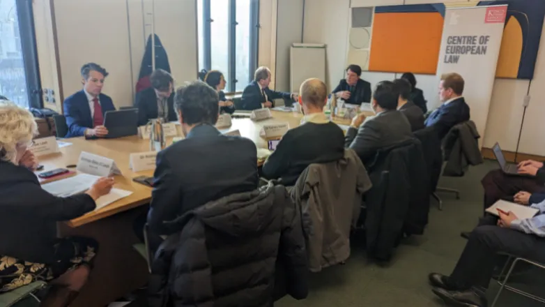 People gathered round a table talking 