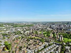 aerial view of housing across a long distance against a blue sky