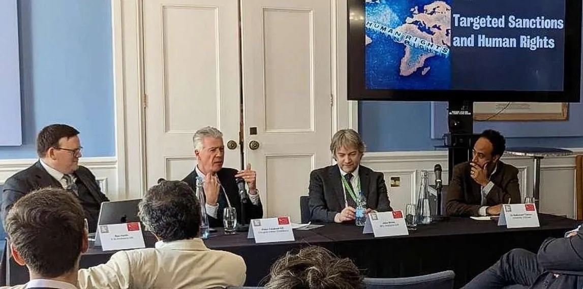 Panellists sitting and talking at an event
