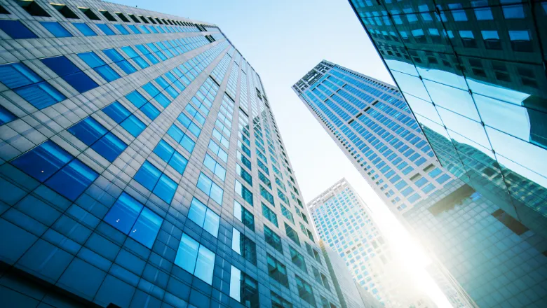 A street level view, looking up at a number of skyscraper buildings