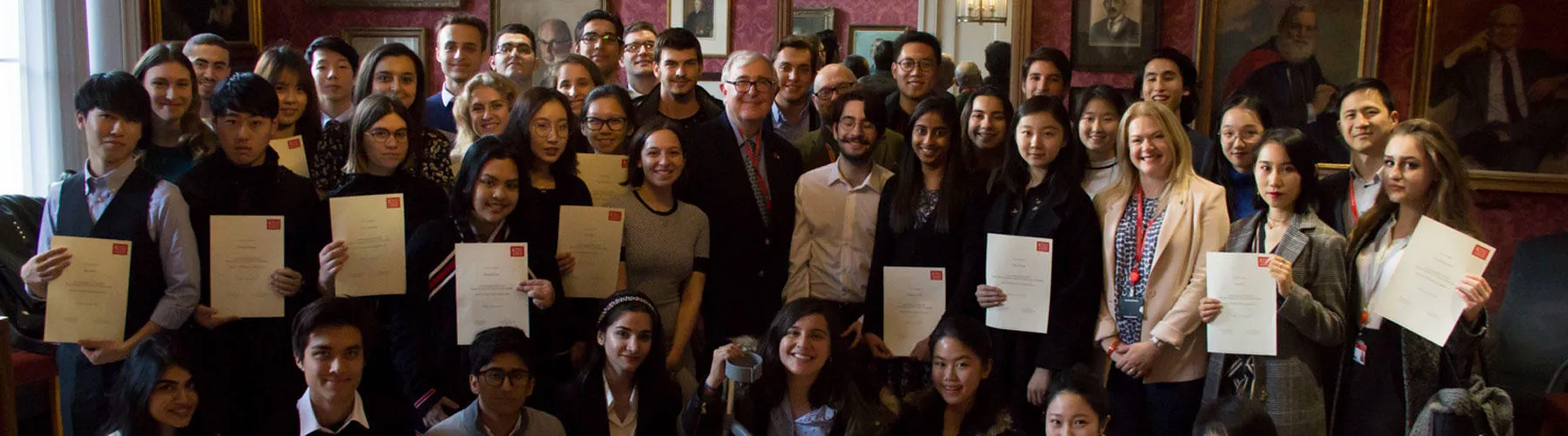 Principal Ed Byrne stands surrounded by scholarship recipients with certificates