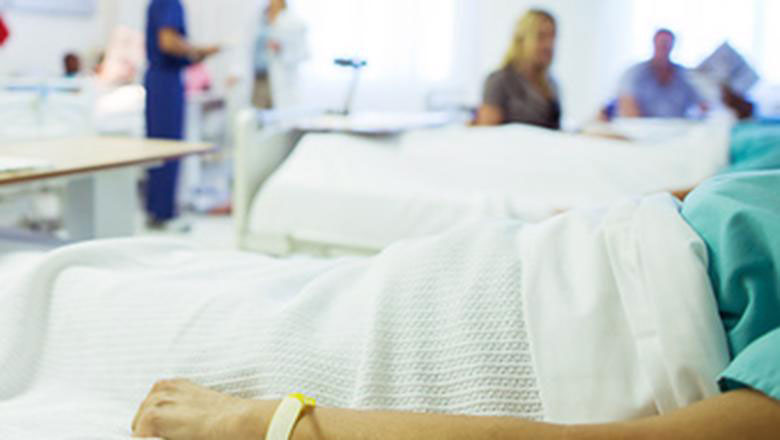 A patient lies in a hospital bed