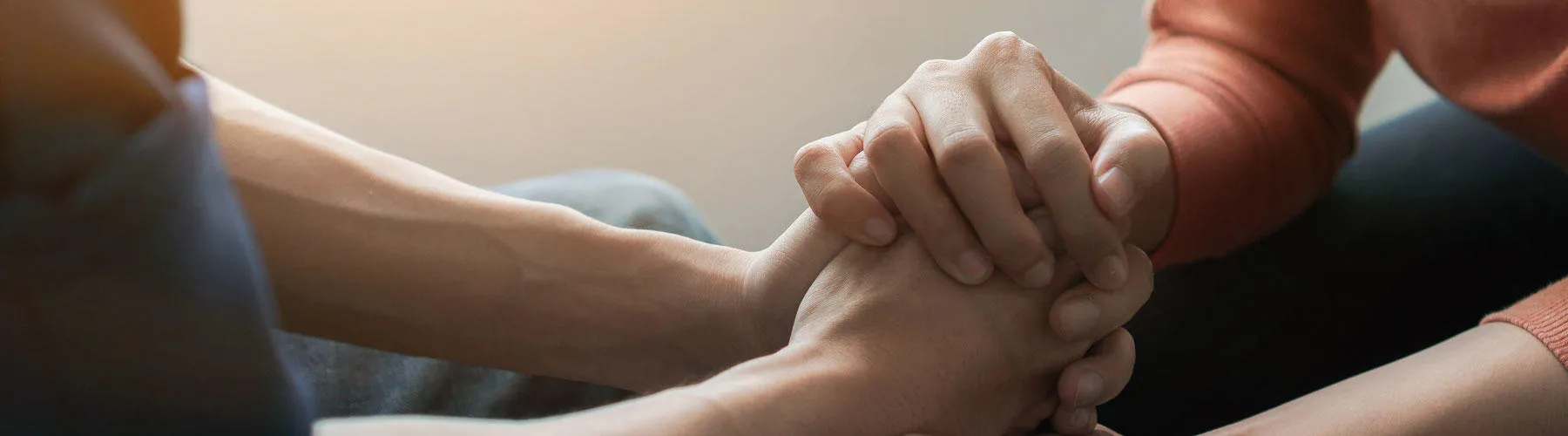 Two people clasp hands