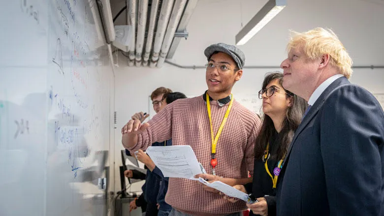 Prime Minister Boris Johnson examines mathematical problems with King's Maths School students