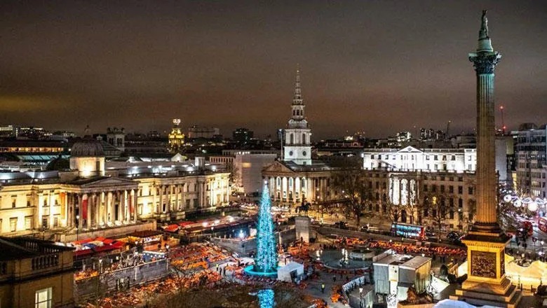 Aerial shot of Trafalgar Square with Nelson's column, the christmas tree and orange participant sleeping bags