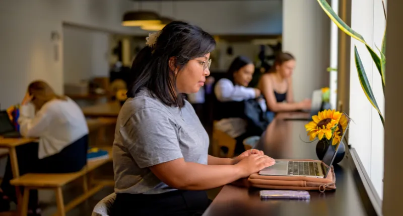 Student sat using their laptop