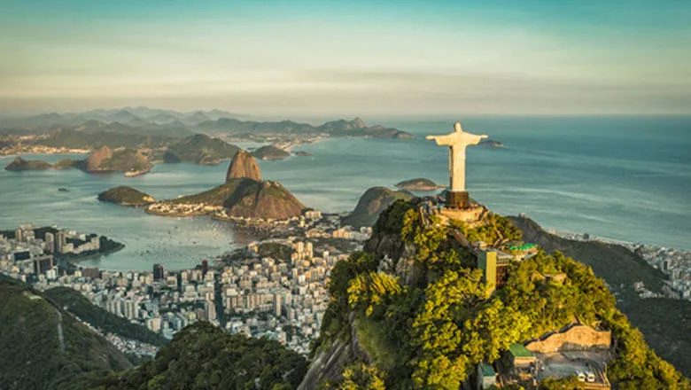 The Christ the Redeemer statue imaged from behind, looking over the city and the ocean