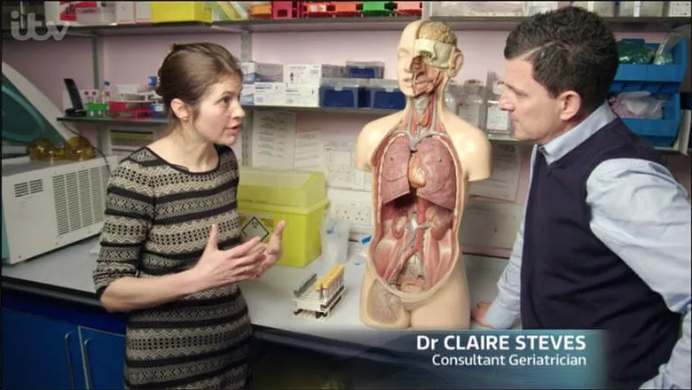 Dr Claire Steves interviewed for ITV with a model of human lungs in background