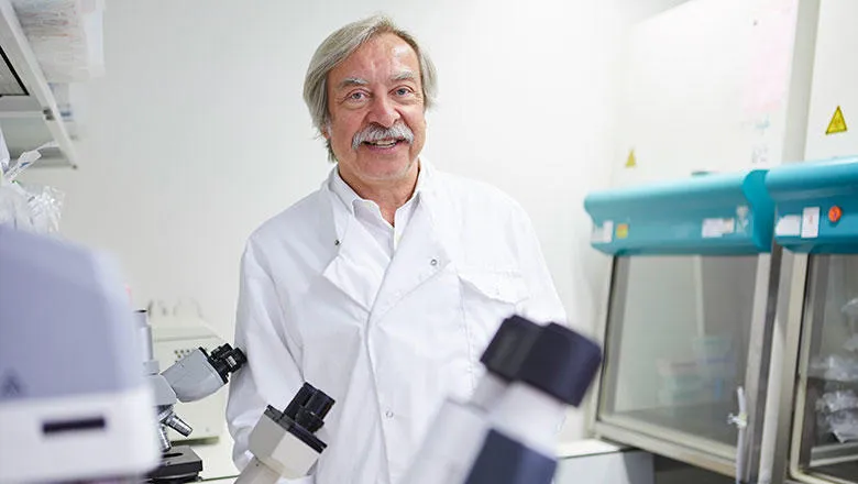 An older man in a white lab coat