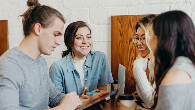 A group of people talking and smiling