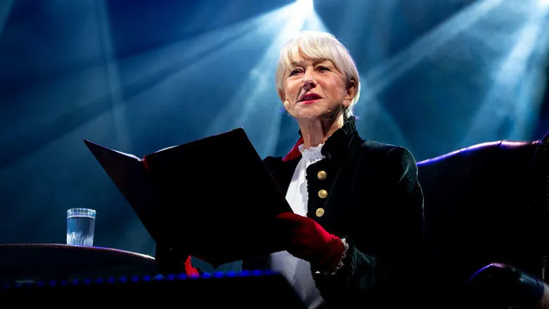 Dame Helen Mirren reads from a book on stage