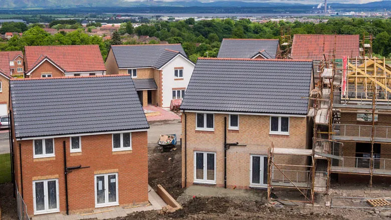 Housing estate under construction with two almost finished in the foreground