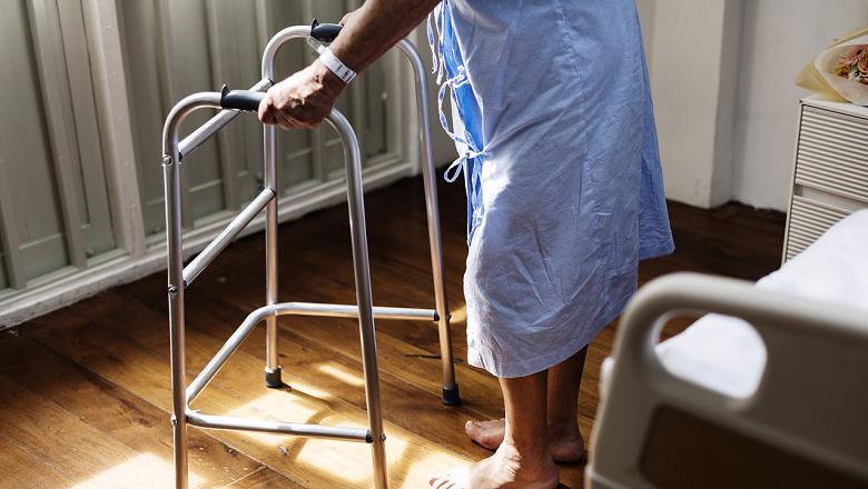 Elderly patient using a zimmer frame walker