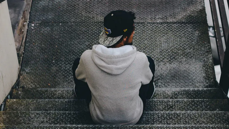 Man sitting on metal stairs