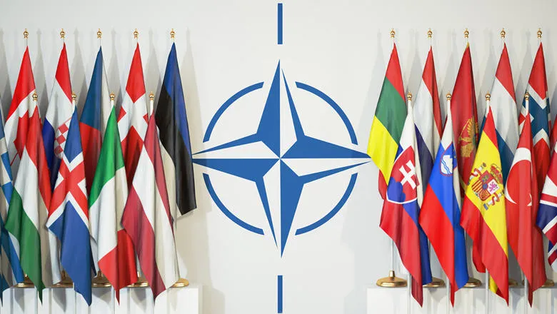 NATO logo surrounded by member flags