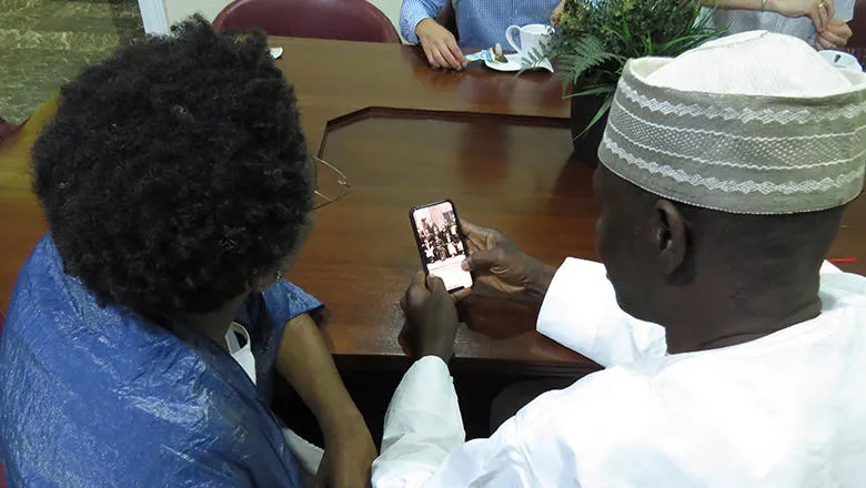 A woman and man look at a phone