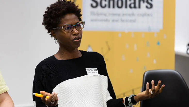 A woman gestures whilst talking