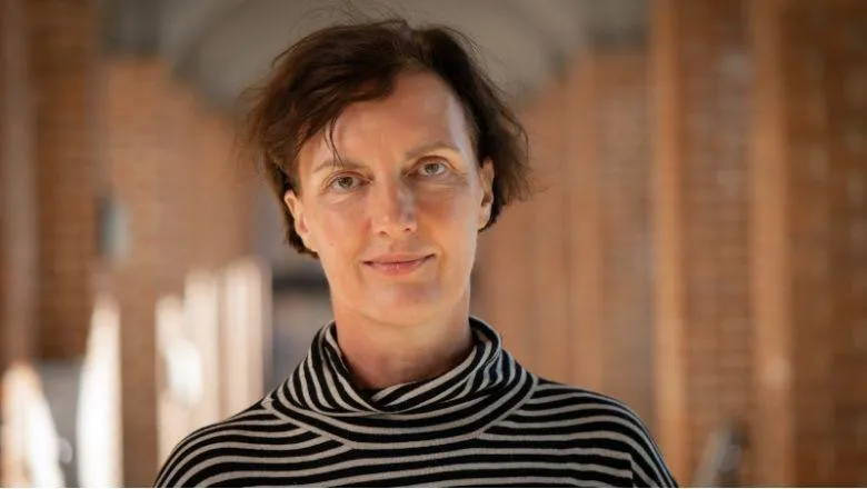 An image of Professor Rachel Mills on a blurred background