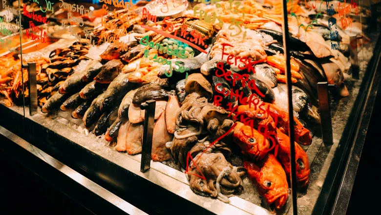 A fish counter at a market, with fish piled up