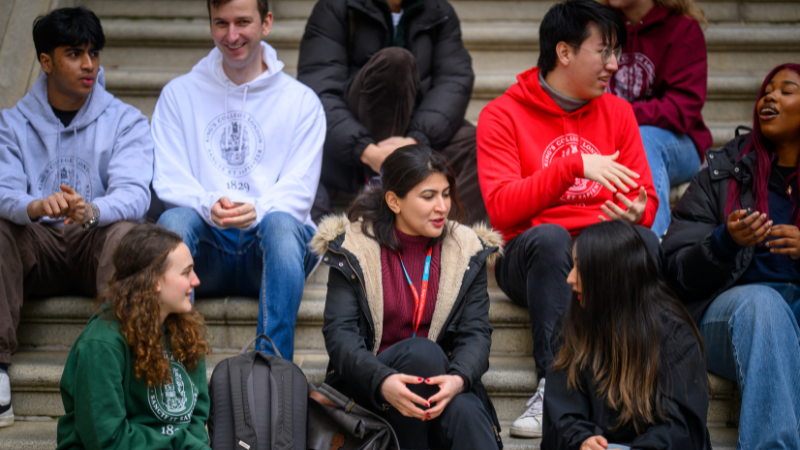 students sitting and talking on Strand steps