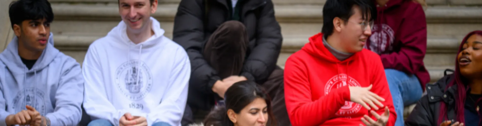 Students sitting on the strand and talking