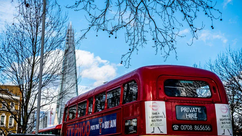 Classic red London bus in front of The Shard