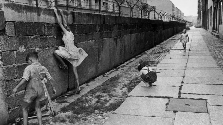 Children climbing the West Berlin Wall in 1962