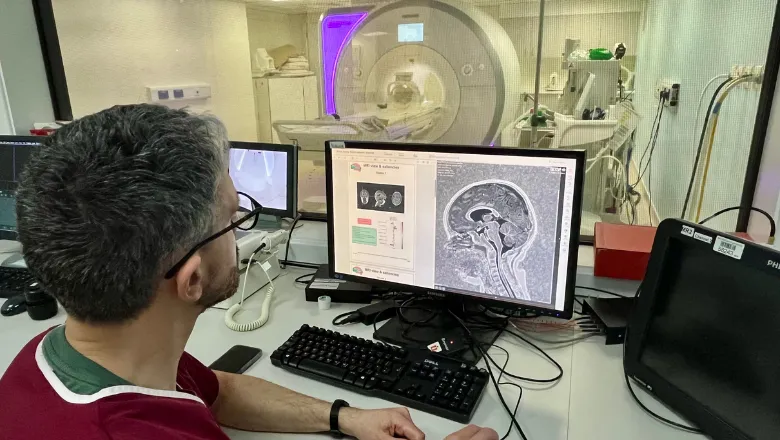 Dr Felice D'Arco, Consultant Radiologist at Great Ormond Street Hospital, reviewing the scan and AI report of a child with complex epilepsy
