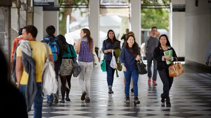 Group of people walking in a corridor.