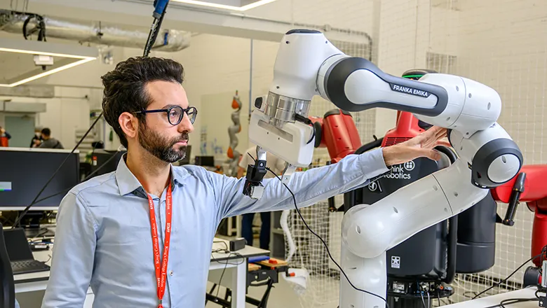 A researcher adjusting a robotic arm
