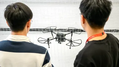 PhD students flying a drone