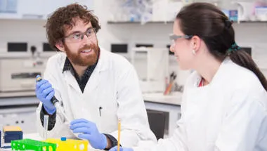 Two people talking in lab
