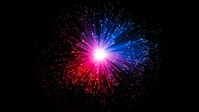Blue and pink fibre optic cables arranged like an explosion