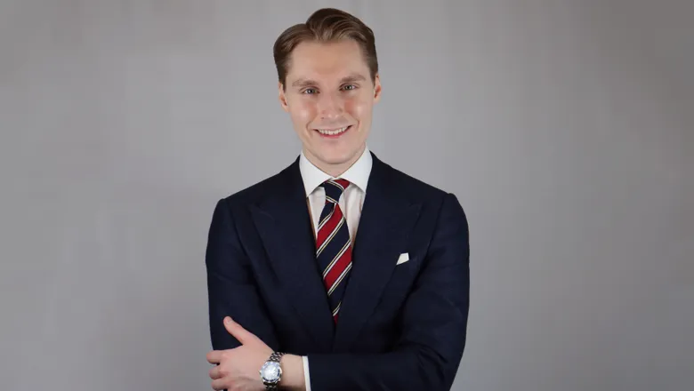 man wearing suit smiling at camera