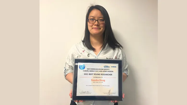 image of young woman holding an award