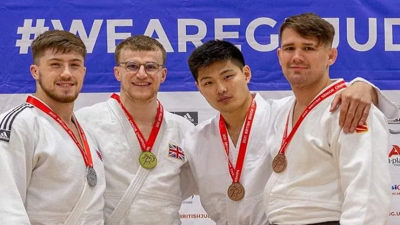 four men wearing white judo suits
