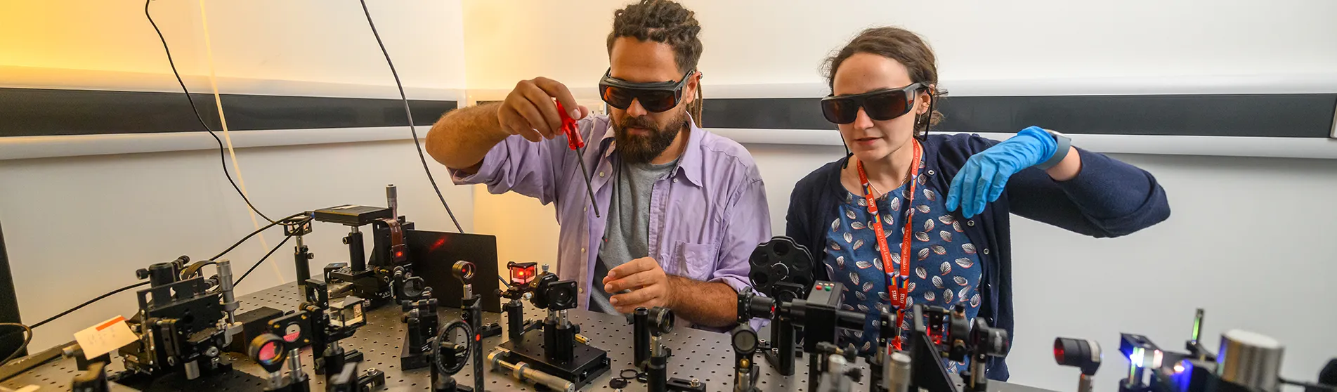 Scientists conducting an experiment in physics wearing dark glasses