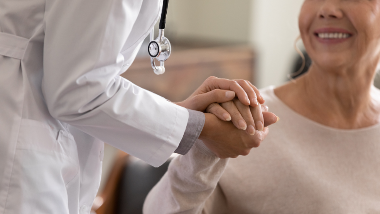 A doctor holding a woman's hand