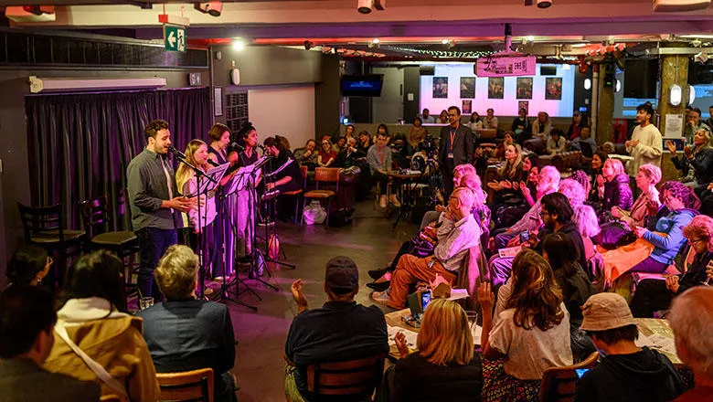 Wide shot of a stage with performers and audience