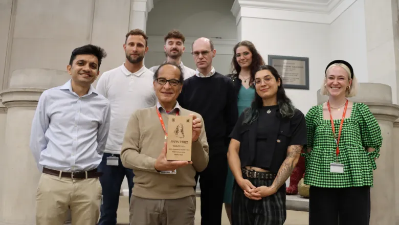 papin prize winners smiling standing in front of stairs