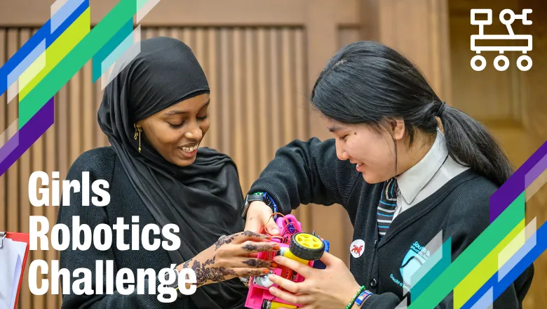 two girls fix a robot, with text saying girls robotics challenge