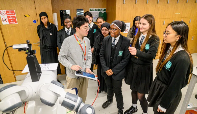 Girls gathering around robotics demo