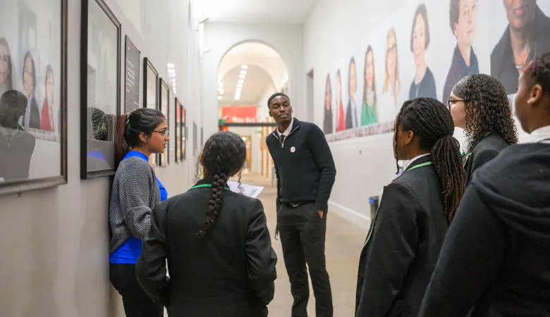 Girls and their teacher listening to tour guide