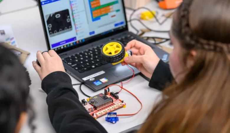 Girl testing out wheel attached to electronic board