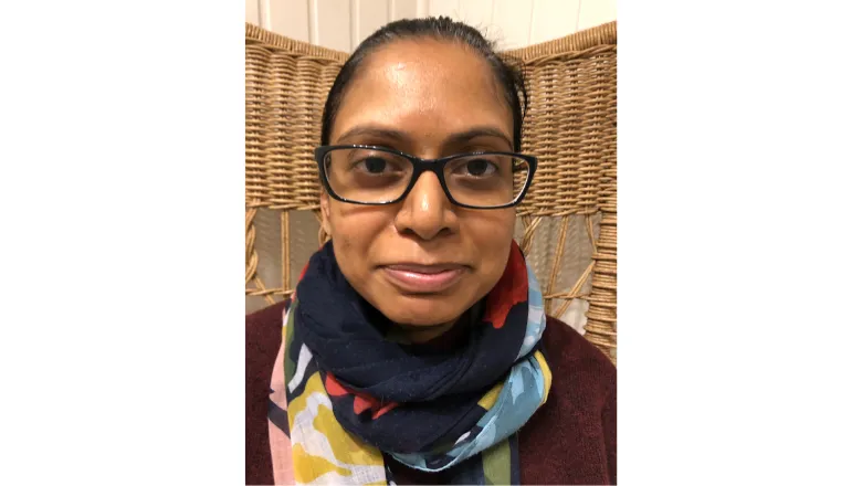 Kovila Coopamootoo smiling and looking at the Camera