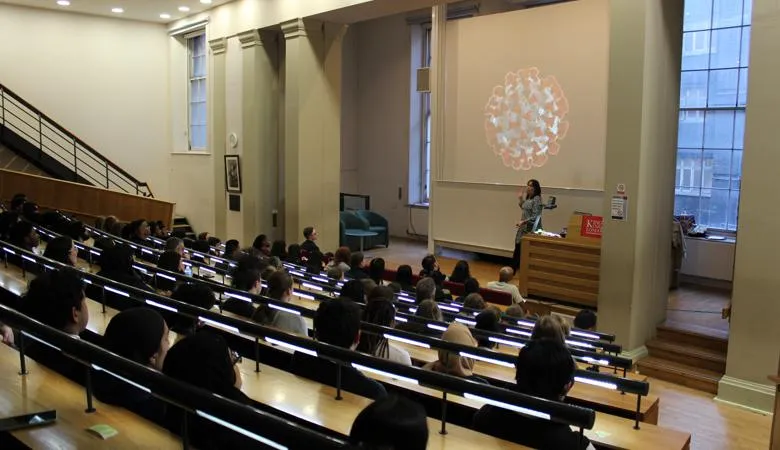 Professor Jen Vissers-Rogers talks to a lecture theatre filled with young people