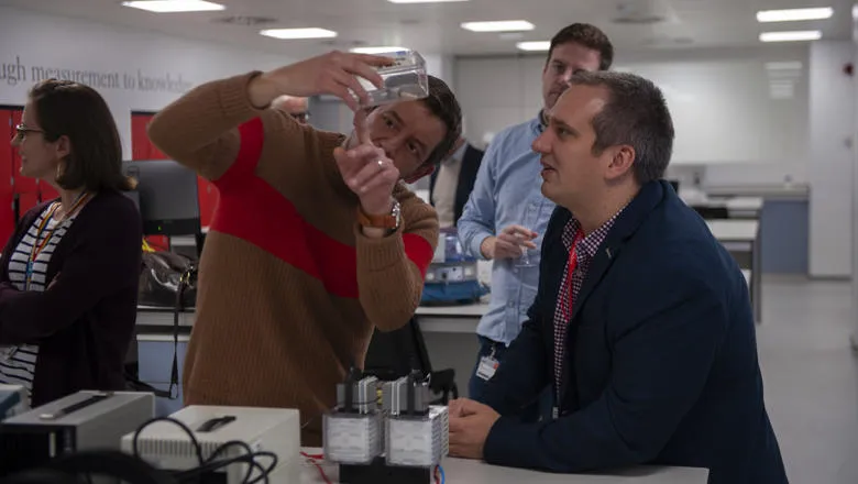 A group of physics researchers using lab equipment