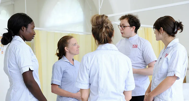 Students talking in a simulation ward