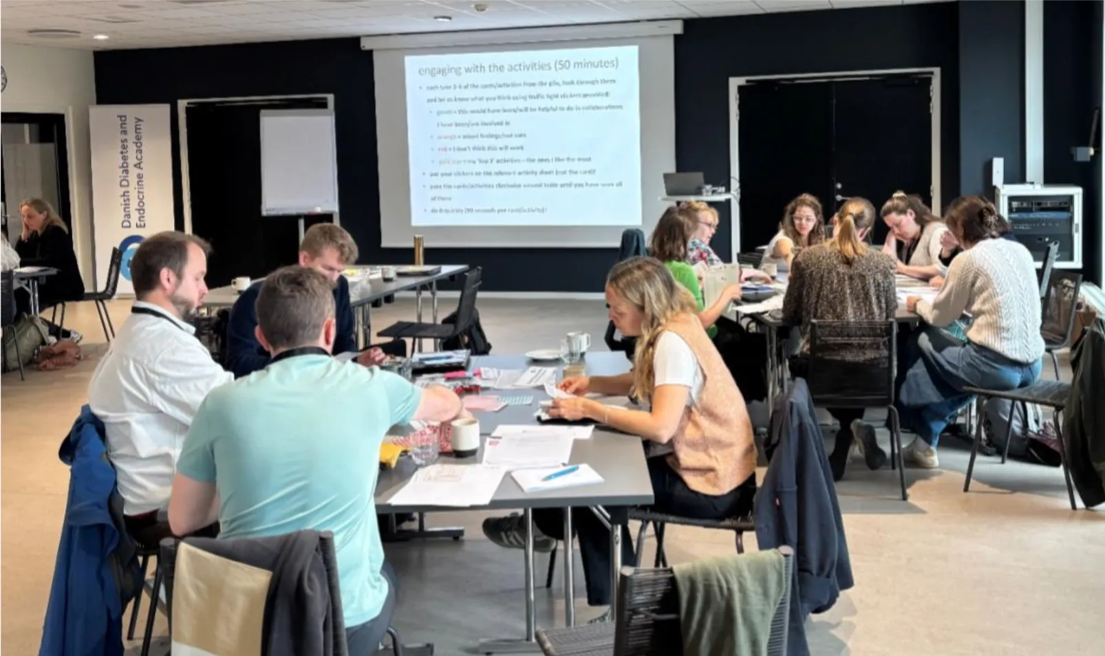 Groups of people working around tables
