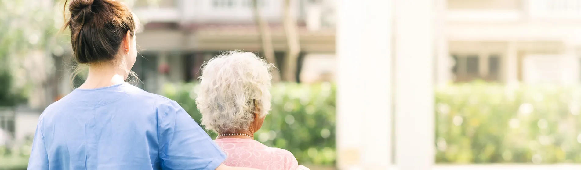 Nurse with arm around an elderly woman